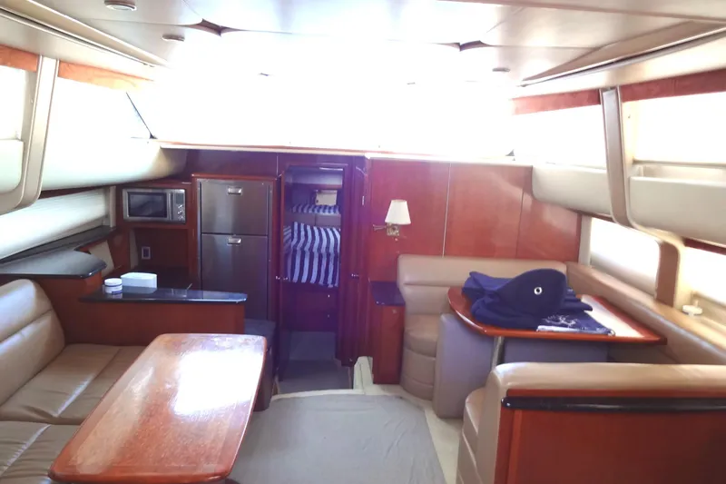 Lit Up Yacht Photos Pics Luxurious interior of a 2007 Meridian 459 yacht with seating, table, and kitchenette.