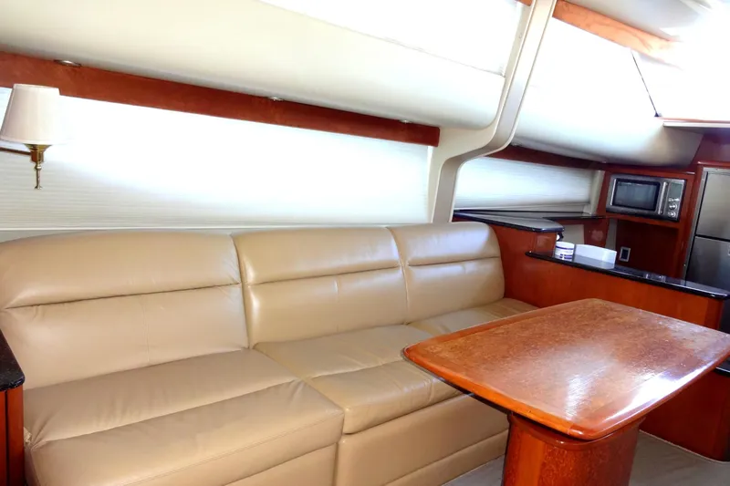 Lit Up Yacht Photos Pics Luxurious interior of 2007 Meridian 459 yacht with leather seating and wooden table.