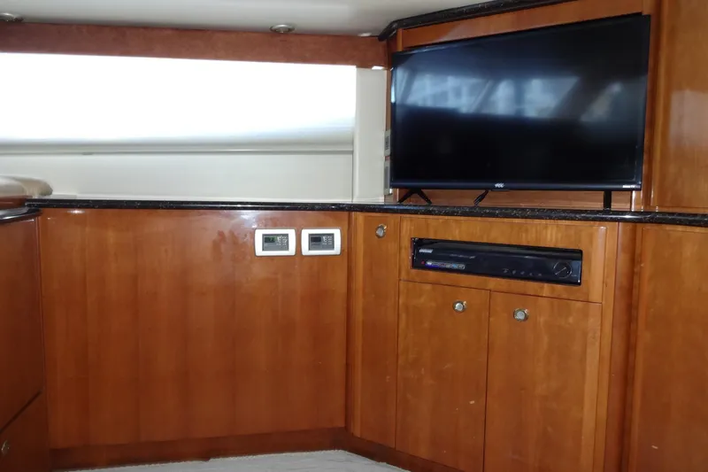 Lit Up Yacht Photos Pics Interior of 2007 Meridian 459 yacht with TV and wooden cabinetry.
