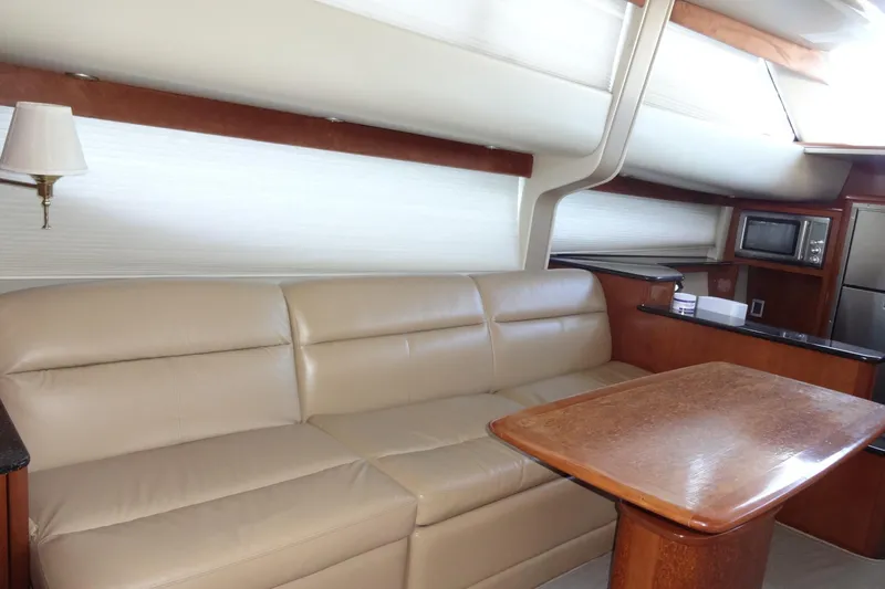 Lit Up Yacht Photos Pics Luxurious interior of 2007 Meridian 459 yacht with leather sofa and wooden table.