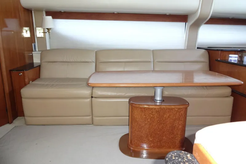 Lit Up Yacht Photos Pics Luxurious interior of 2007 Meridian 459 yacht with beige leather seating and wooden table.