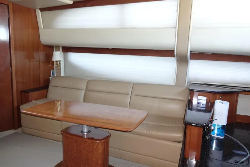 Lit Up Yacht Photos Pics Luxurious interior of 2007 Meridian 459 yacht with leather seating and wooden table.
