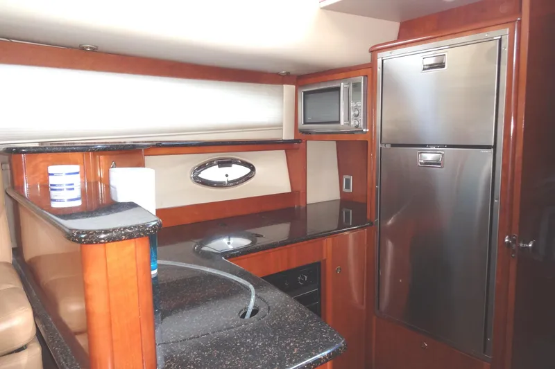 Lit Up Yacht Photos Pics Luxurious 2007 Meridian 459 yacht kitchen with modern appliances and elegant wood finish.