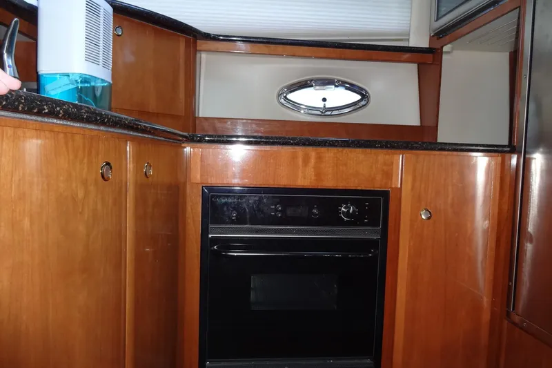 Lit Up Yacht Photos Pics 2007 Meridian 459 yacht kitchen with wood cabinetry and built-in oven.