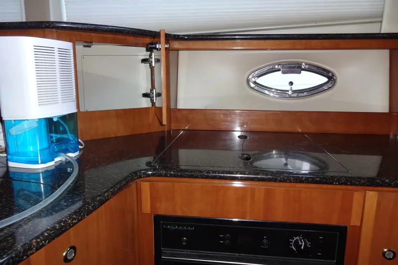 Lit Up Yacht Photos Pics 2007 Meridian 459 yacht kitchen with sleek countertops and modern appliances.