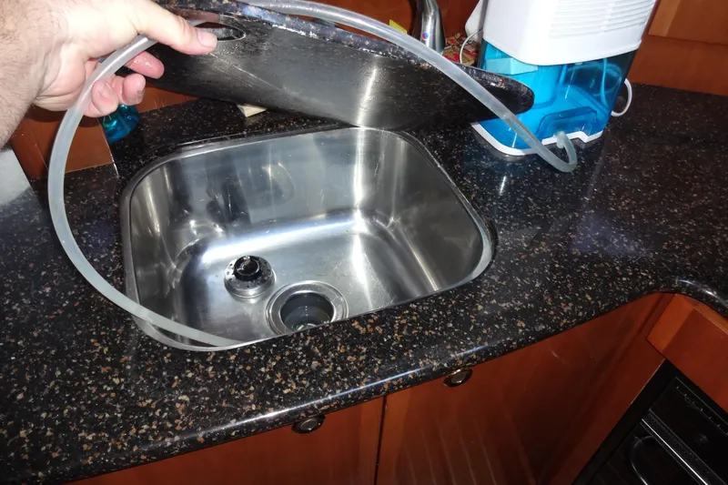 Lit Up Yacht Photos Pics Stainless steel sink in 2007 Meridian 459 yacht kitchen with countertop and hose.