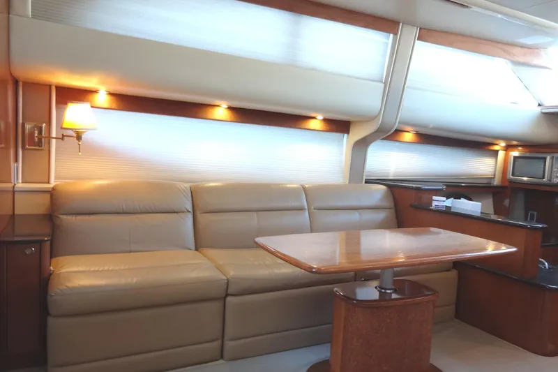 Lit Up Yacht Photos Pics Luxurious interior of 2007 Meridian 459 yacht with leather seating and wooden table.