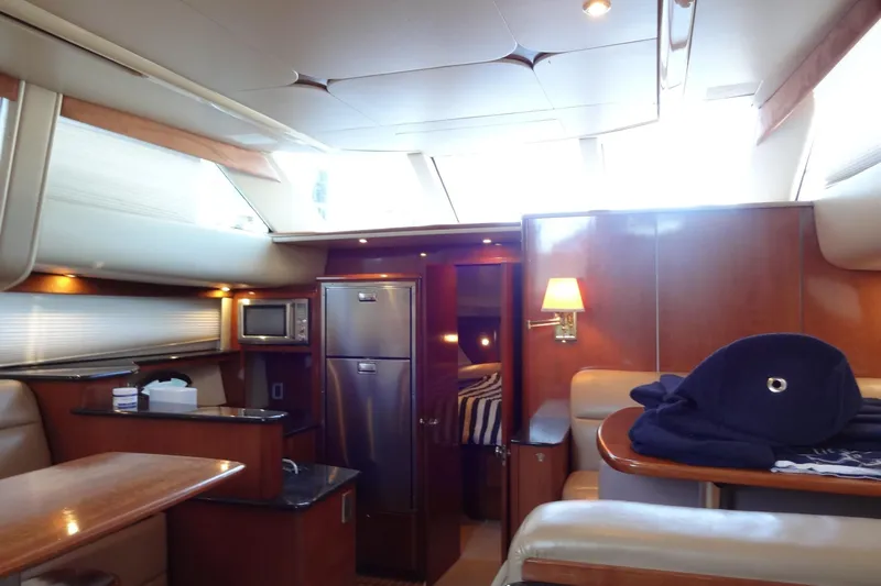 Lit Up Yacht Photos Pics Luxurious interior of 2007 Meridian 459 yacht with modern kitchen and cozy seating area.