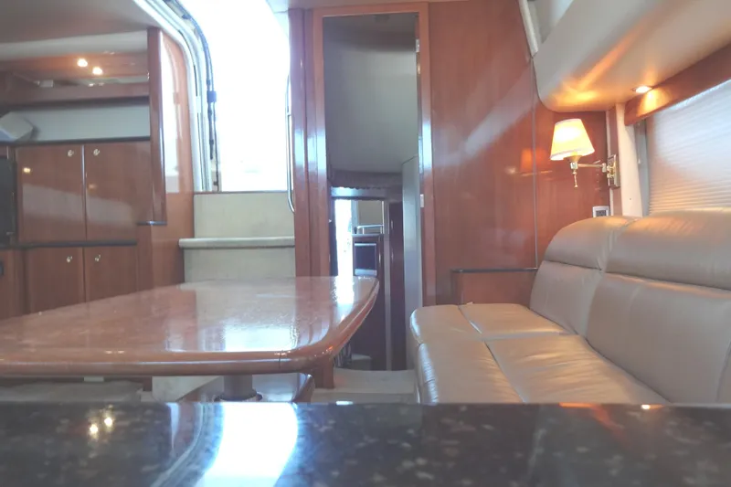 Lit Up Yacht Photos Pics Luxurious interior of a 2007 Meridian 459 yacht with elegant wood finishes and comfortable seating.