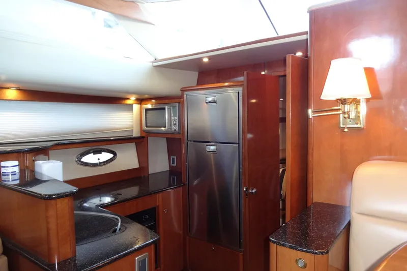Lit Up Yacht Photos Pics Luxurious 2007 Meridian 459 yacht interior with modern kitchen and elegant wood finishes.