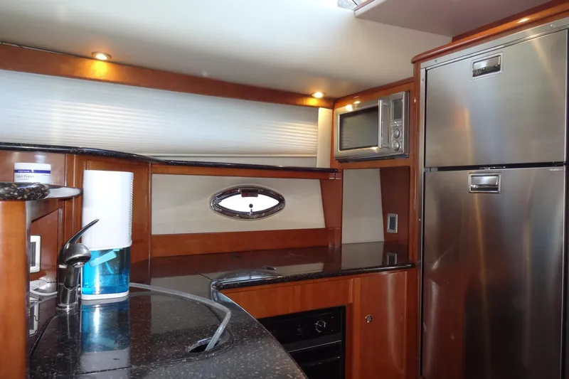 Lit Up Yacht Photos Pics Luxurious kitchen interior of 2007 Meridian 459 yacht with modern appliances and sleek design.