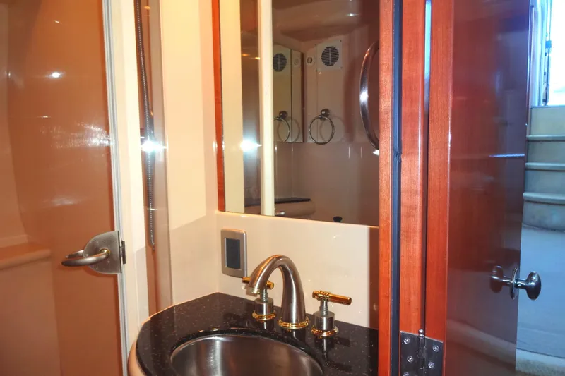 Lit Up Yacht Photos Pics Luxurious bathroom interior of 2007 Meridian 459 yacht with elegant fixtures and wooden accents.