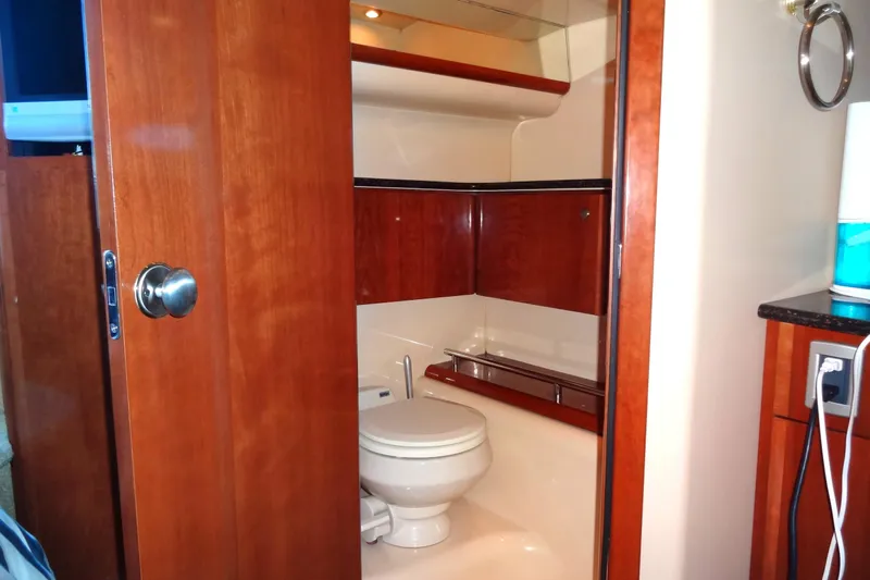 Lit Up Yacht Photos Pics 2007 Meridian 459 yacht bathroom with wooden cabinetry and modern fixtures.