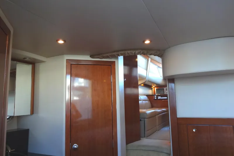 Lit Up Yacht Photos Pics Luxurious interior of 2007 Meridian 459 yacht with wood finishes and cozy seating area.