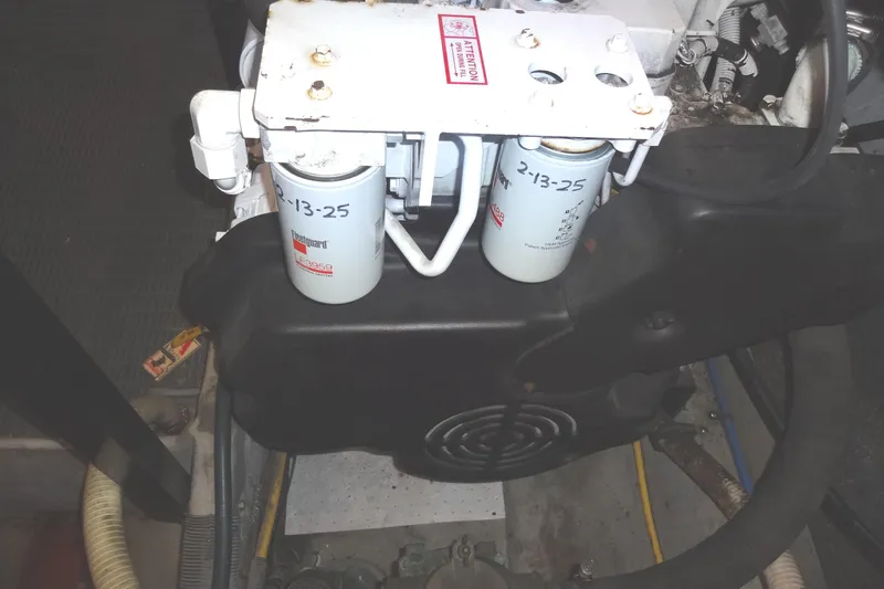 Lit Up Yacht Photos Pics Engine compartment of a 2007 Meridian 459, featuring dual fuel filters and mechanical components.