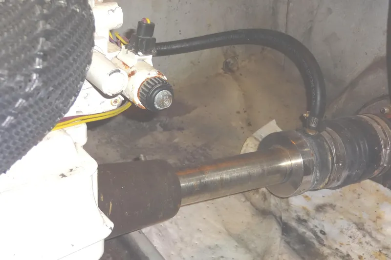 Lit Up Yacht Photos Pics Engine component of a 2007 Meridian 459 yacht, featuring a starboard metal shaft and connected hoses.