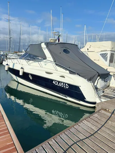  Yacht Photos Pics 2009 Cranchi Endurance 41 yacht docked at marina, covered with gray canopy.