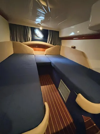  Yacht Photos Pics 2009 Cranchi Endurance 41 cabin interior with blue bedding and wood accents.