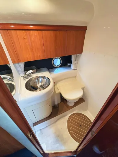  Yacht Photos Pics 2009 Cranchi Endurance 41 yacht bathroom with sink, toilet, and wooden cabinetry.