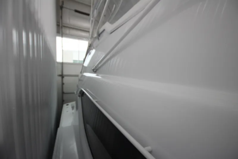 Rollwind Yacht Photos Pics Hatteras 55 Convertible 2001 yacht in storage, side view, sleek white exterior.