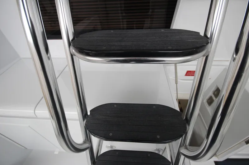 Rollwind Yacht Photos Pics Stainless steel ladder on 2001 Hatteras 55 Convertible yacht.