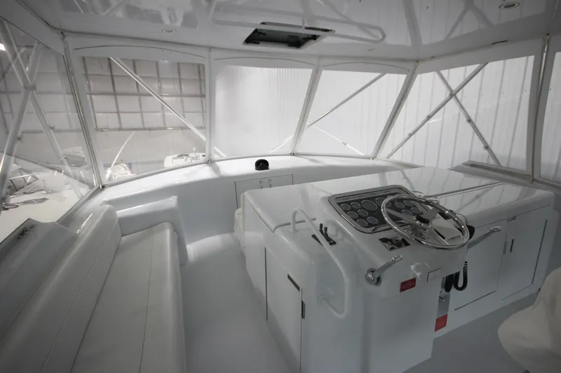 Rollwind Yacht Photos Pics Interior helm of 2001 Hatteras 55 Convertible yacht, featuring steering wheel and seating.
