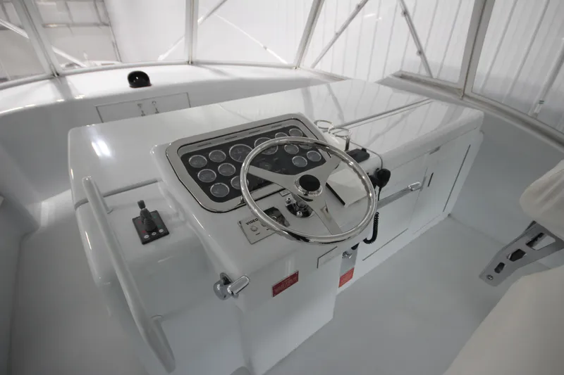 Rollwind Yacht Photos Pics Helm of 2001 Hatteras 55 Convertible yacht with steering wheel and control panel.