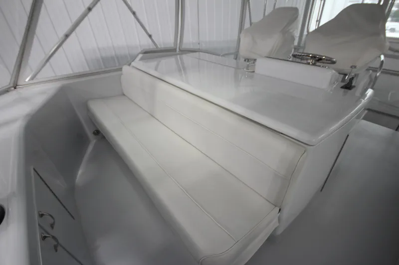 Rollwind Yacht Photos Pics 2001 Hatteras 55 Convertible yacht interior with white seating and helm station.