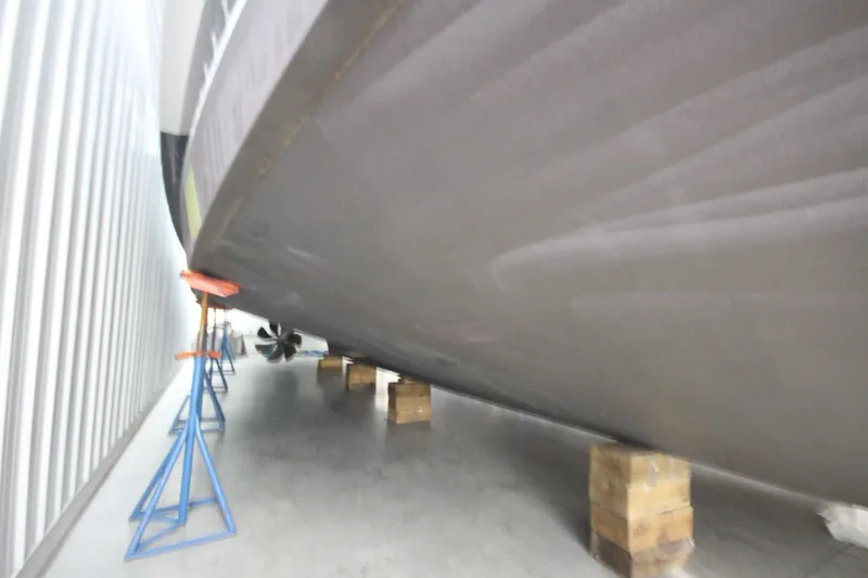 Rollwind Yacht Photos Pics Hatteras 55 Convertible 2001 yacht hull on stands in storage facility.