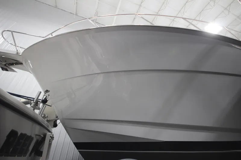 Rollwind Yacht Photos Pics 2001 Hatteras 55 Convertible yacht in indoor storage, showcasing sleek hull design.