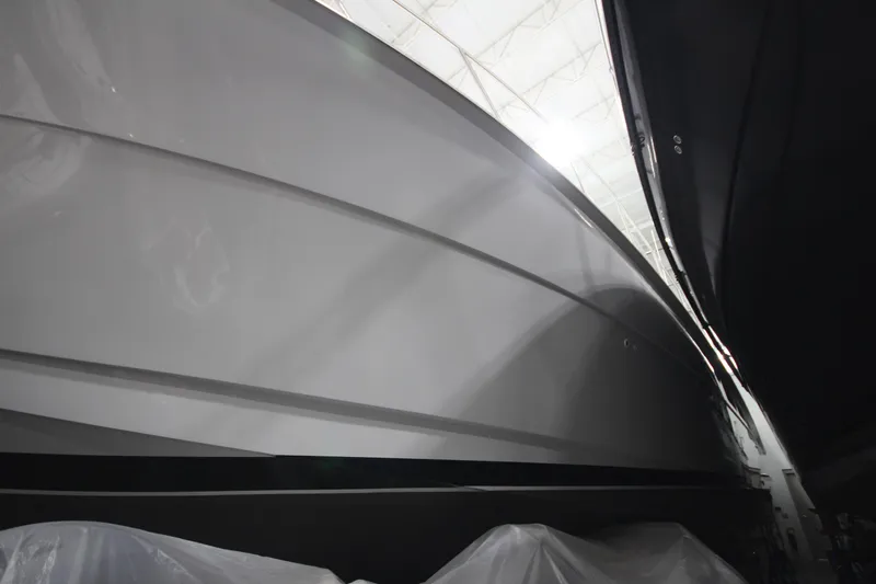 Rollwind Yacht Photos Pics 2001 Hatteras 55 Convertible yacht hull in a dimly lit storage area.