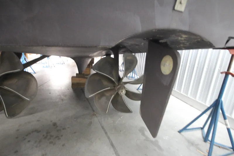 Rollwind Yacht Photos Pics Propellers and rudder of a 2001 Hatteras 55 Convertible yacht in a maintenance facility.