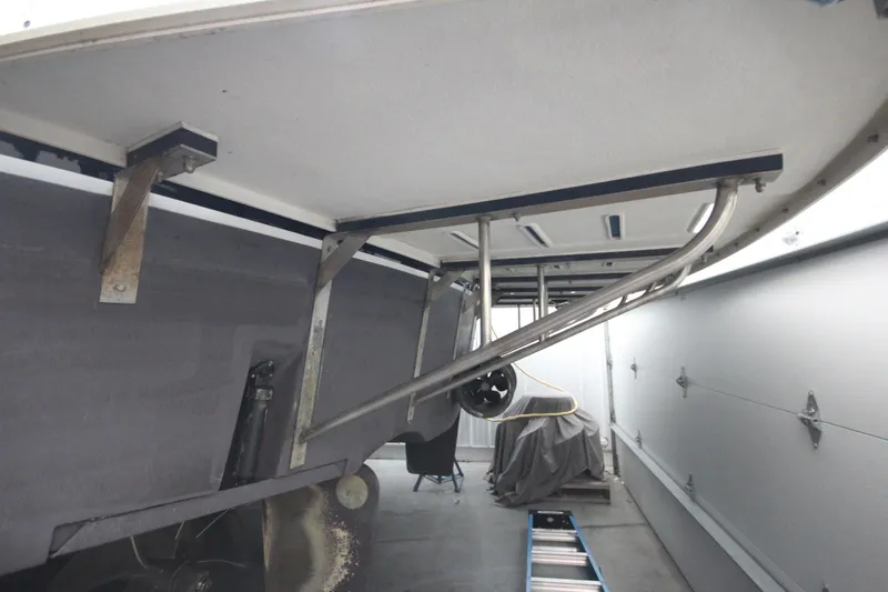 Rollwind Yacht Photos Pics Hatteras 55 Convertible 2001 boat underside in storage, showing propeller and support structure.