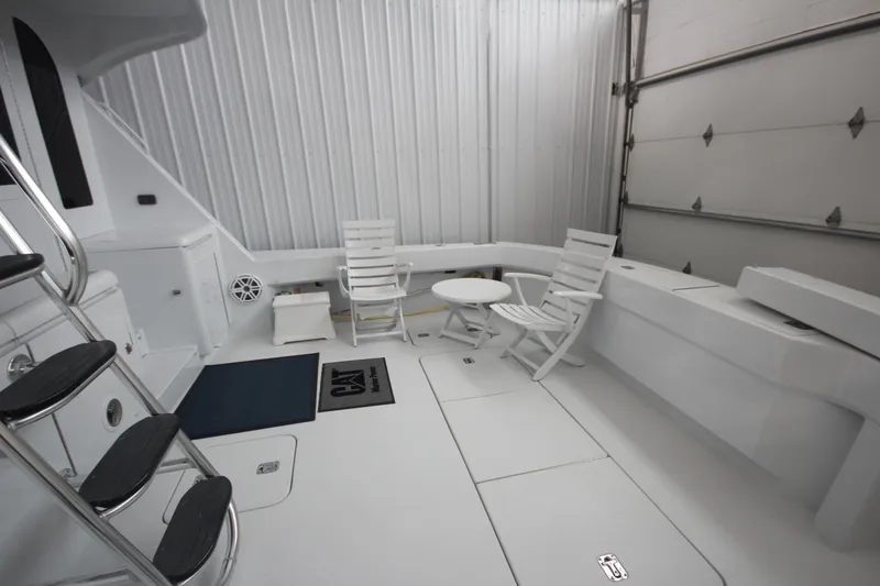 Rollwind Yacht Photos Pics Spacious deck of 2001 Hatteras 55 Convertible yacht with seating and table.