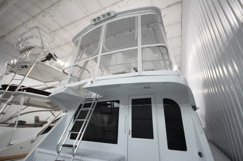 Rollwind Yacht Photos Pics 2001 Hatteras 55 Convertible yacht in storage, featuring a sleek design and enclosed flybridge.