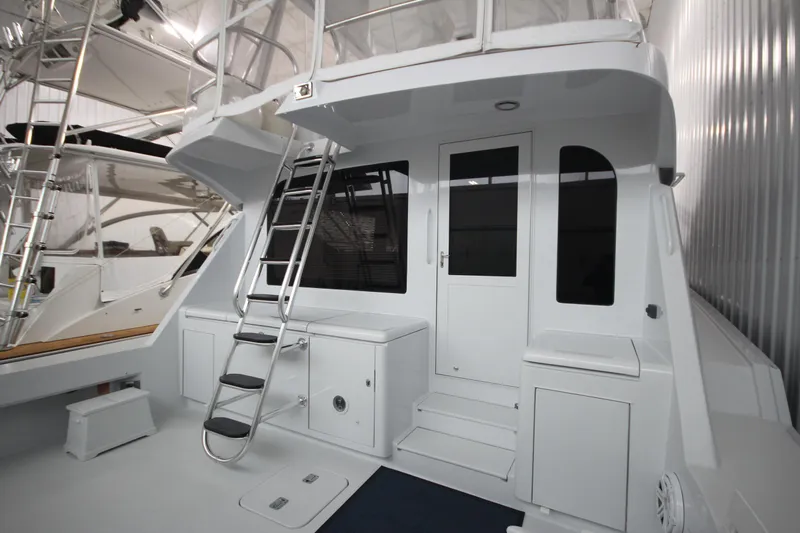 Rollwind Yacht Photos Pics 2001 Hatteras 55 Convertible yacht with sleek white exterior and ladder access.