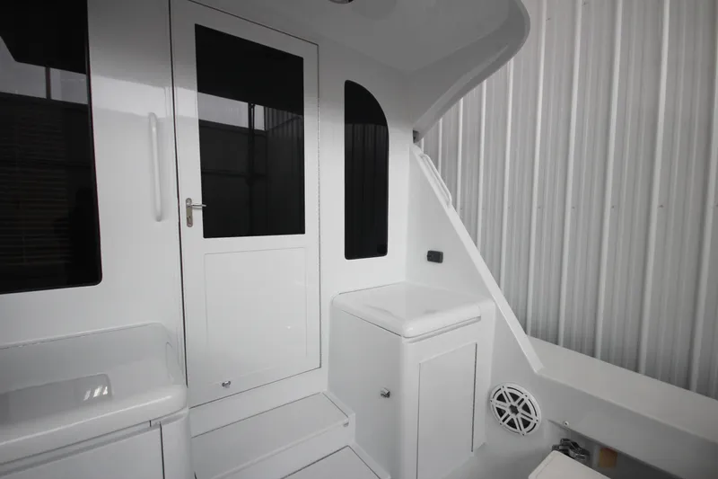 Rollwind Yacht Photos Pics Interior view of 2001 Hatteras 55 Convertible yacht, featuring sleek white design and modern amenities.