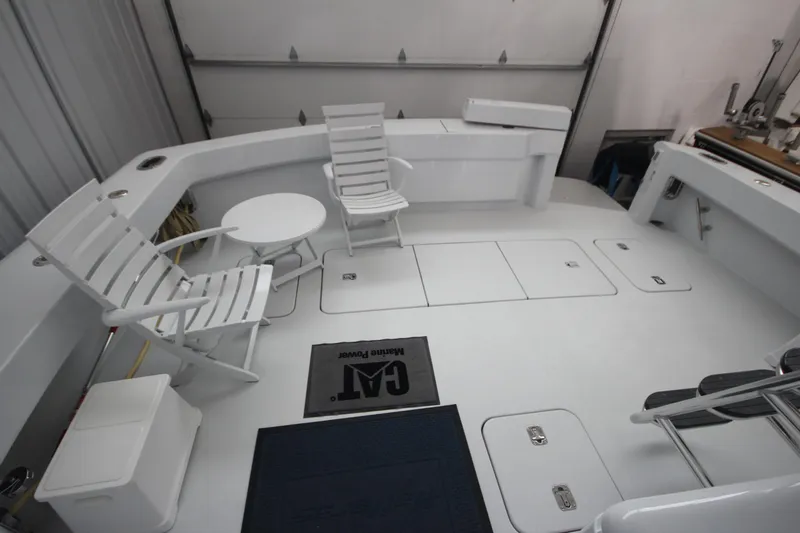 Rollwind Yacht Photos Pics Spacious deck of 2001 Hatteras 55 Convertible with white seating and table.