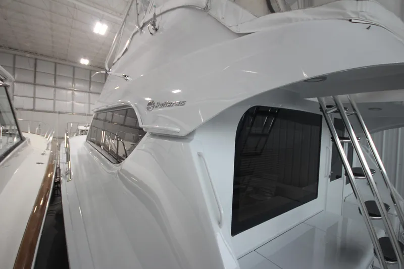 Rollwind Yacht Photos Pics 2001 Hatteras 55 Convertible yacht in indoor storage, side view.