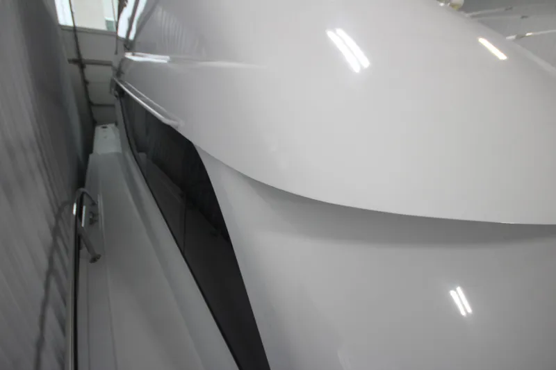 Rollwind Yacht Photos Pics 2001 Hatteras 55 Convertible yacht, sleek white exterior in storage.