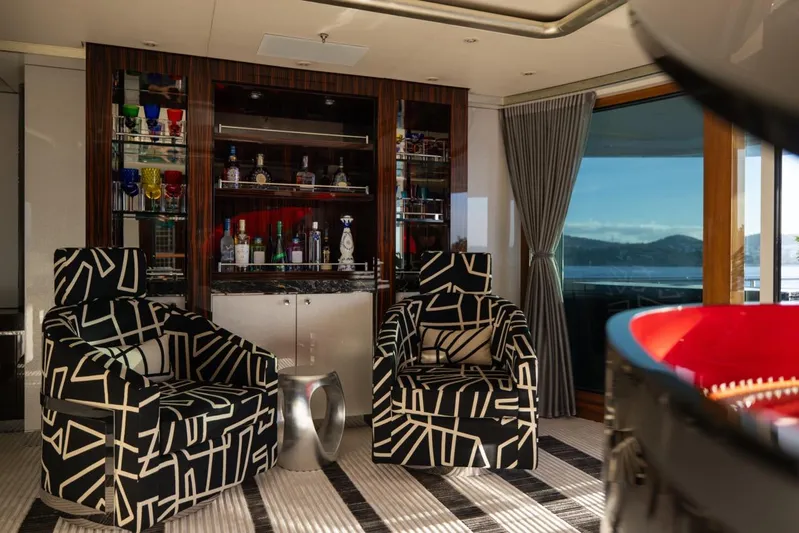 Alfa G Yacht Photos Pics Luxurious yacht interior with patterned chairs, bar, and ocean view. Oceanco 60 Meters, 2004.