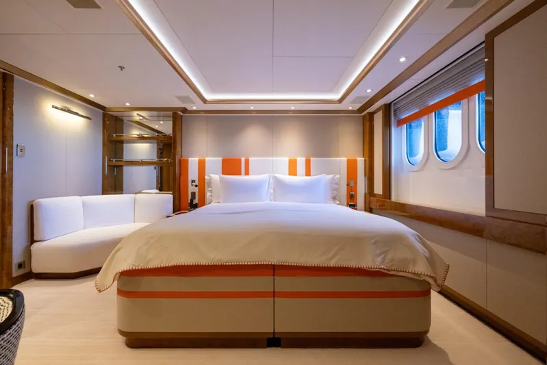 Alfa G Yacht Photos Pics Luxurious yacht bedroom with modern decor, featuring a large bed and porthole windows. Oceanco 60 Meters, 2004.