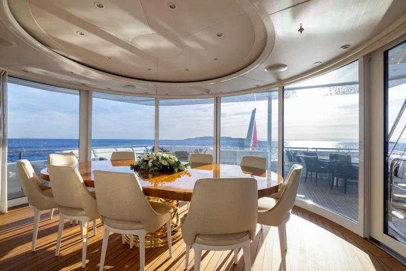 Alfa G Yacht Photos Pics Luxurious yacht interior with round dining table, panoramic ocean view; Oceanco 60 Meters, 2004.