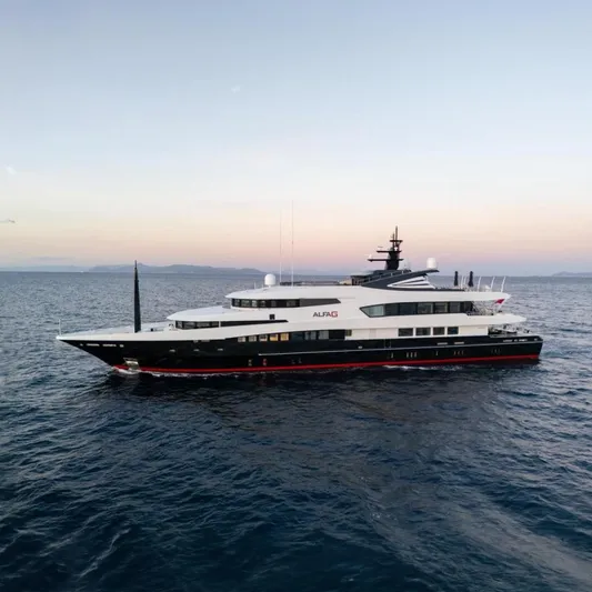 Alfa G Yacht Photos Pics Luxurious 2004 Oceanco 60-meter yacht cruising at sunset on open sea.