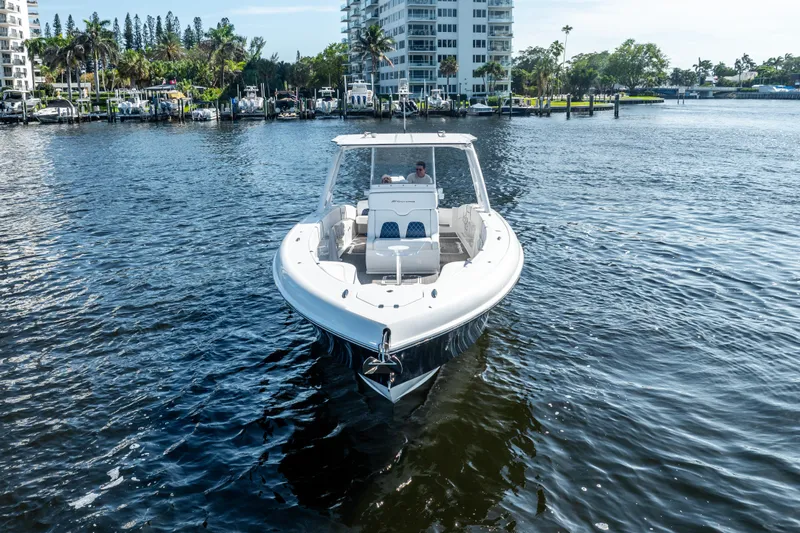  Yacht Photos Pics 2020 Midnight Express 34 Open boat cruising on a sunny day in a marina.