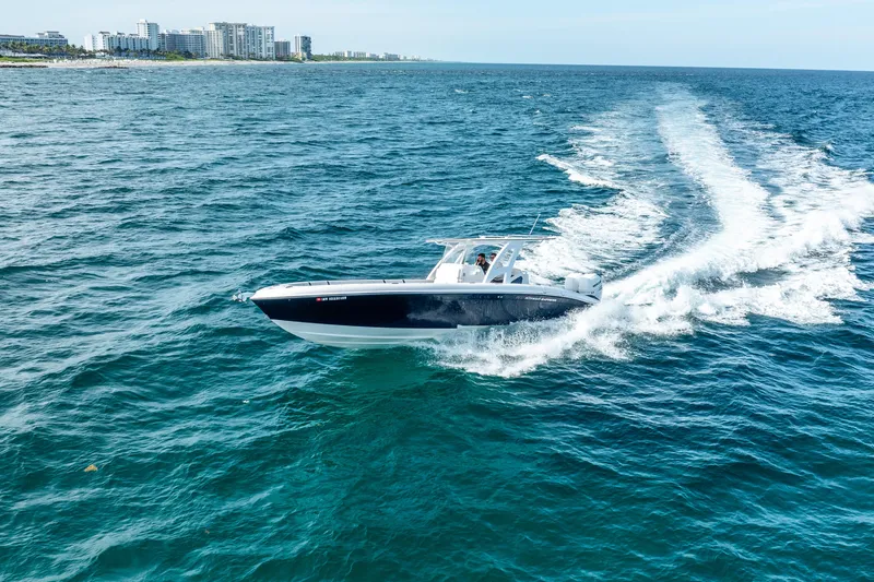  Yacht Photos Pics 2020 Midnight Express 34 Open boat cruising on the ocean near the coastline.