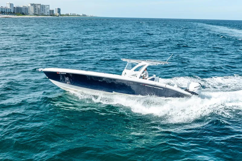  Yacht Photos Pics 2020 Midnight Express 34 Open boat cruising on the ocean near the coastline.