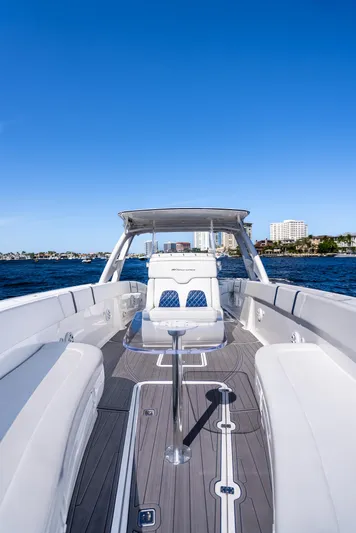  Yacht Photos Pics 2020 Midnight Express 34 Open boat with white seating and blue accents on the water.
