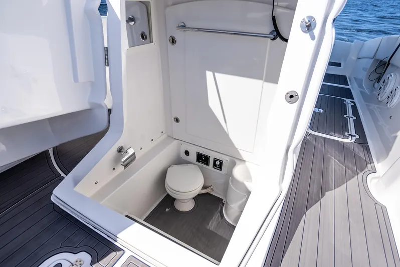  Yacht Photos Pics 2020 Midnight Express 34 Open boat interior with compact marine toilet.