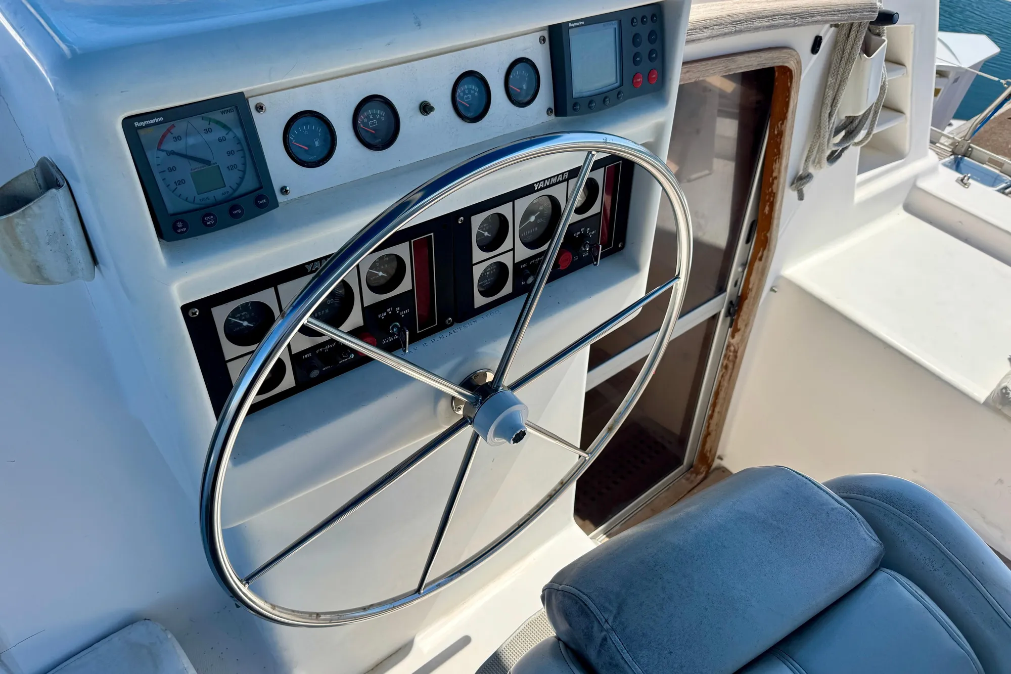 1992 Wauquiez Kronos yacht helm with steering wheel and navigation instruments.